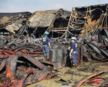 Certified Fire Investigators examining debris in an arson crime scene