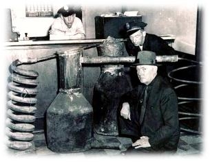 An agent and police officers next to a seized still