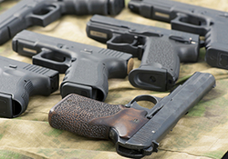 Different handguns lying on a table