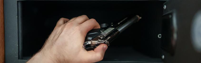 Man puts a firearm in a safe