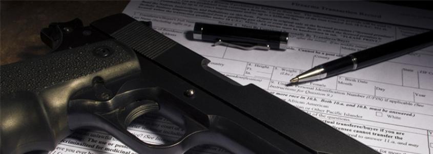 Firearm and open pen on top of an ATF form