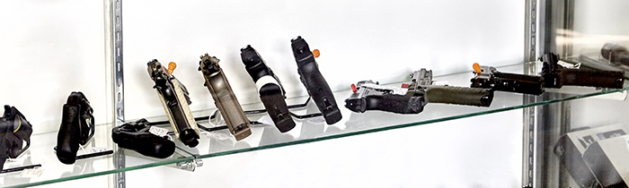 Handguns on shelves