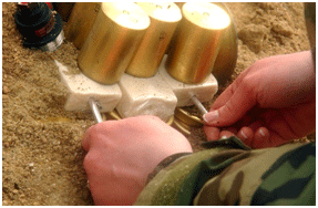 A military person handling a plastic explosive