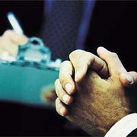 Image of a person marking of items on a list. 