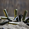 Image of bullets in sand.