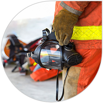 Firefighter holding a mask
