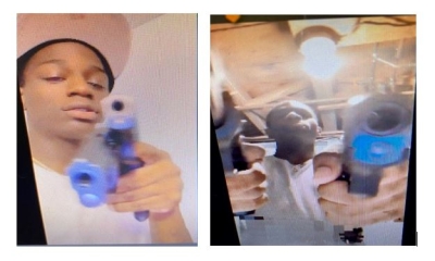 Suspect pointing gun at camera