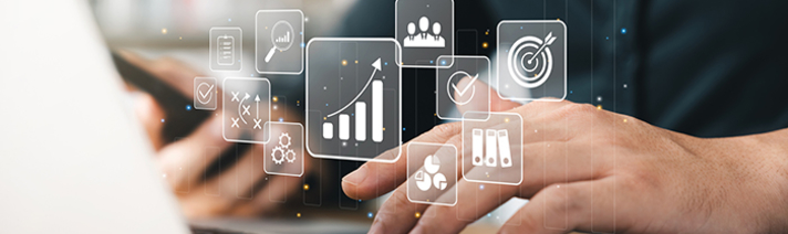 A person typing on a keyboard with data graphics 