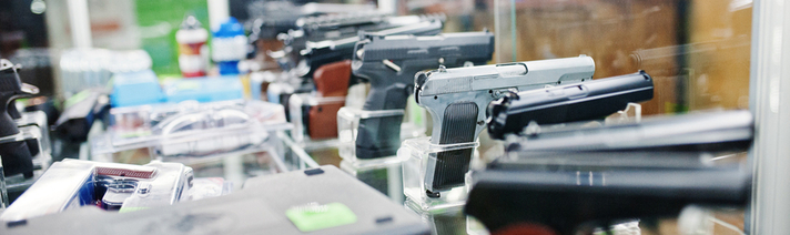 Row of guns lined up on a counter