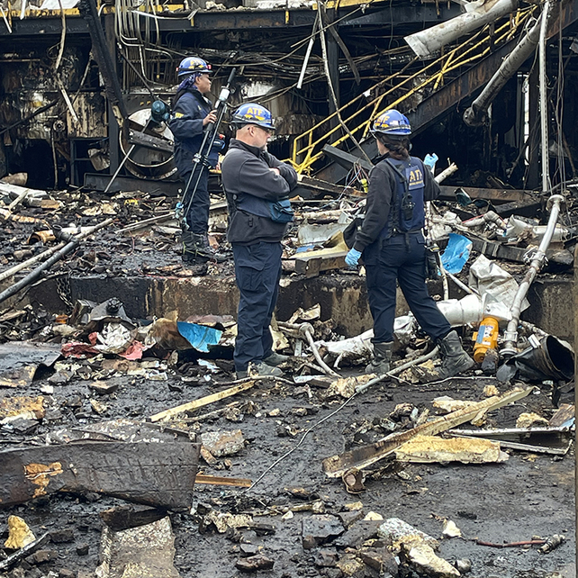 Three agents standing at a crime scene