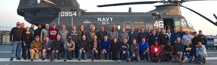 K-9 teams across the country in front of an aircraft carrier