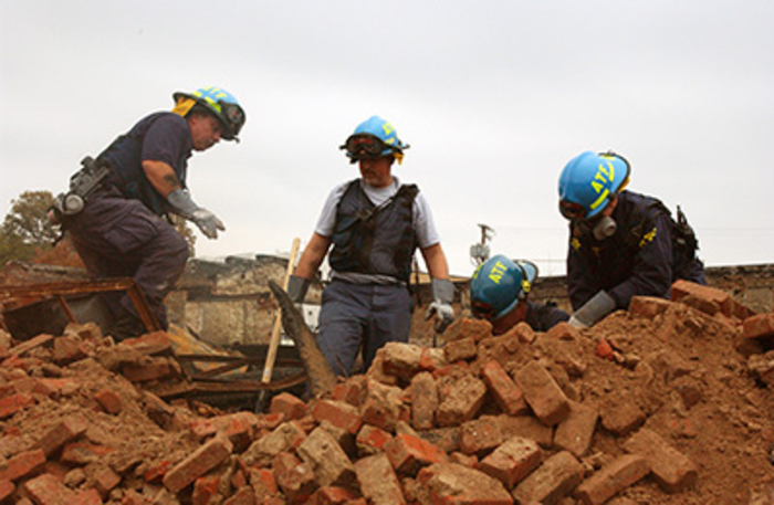 Four agents go through remnants of an explosion