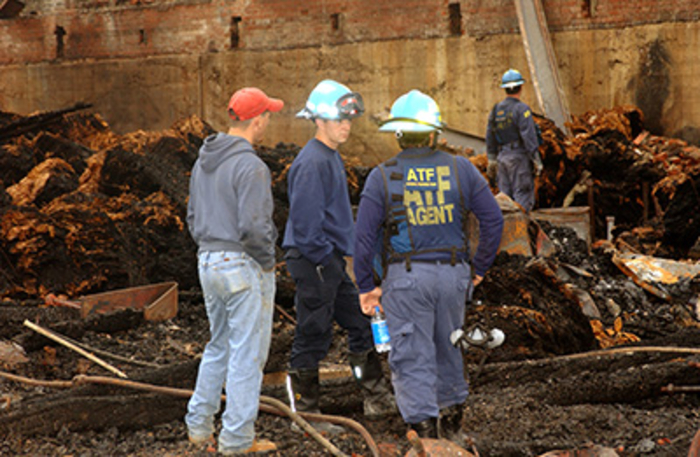 ATF agents sift through the remnants of an explosion