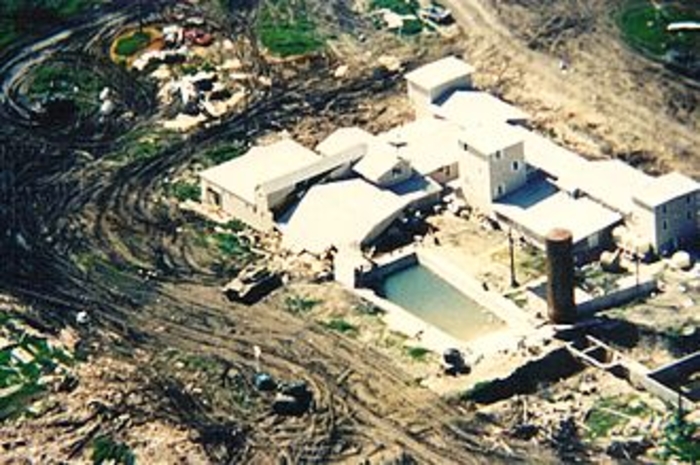 Aerial view of the Mount Carmel compound with smoke coming out of the windows.