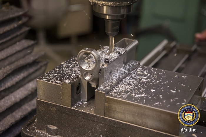 Milling material from fire control cavity