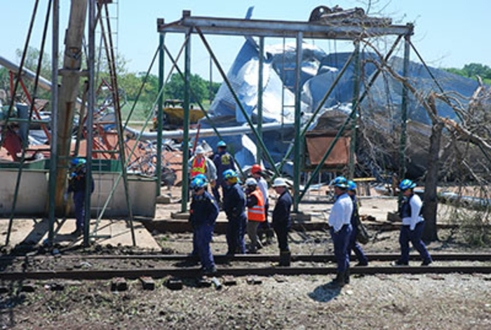 Agents looking over railroad tracks