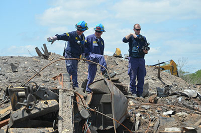 Agent pointing to debris