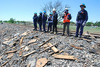 Multiple agents looking over debris near a railroad track