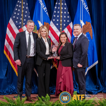 An individual receives an award at the Department of Justice Awards Ceremony