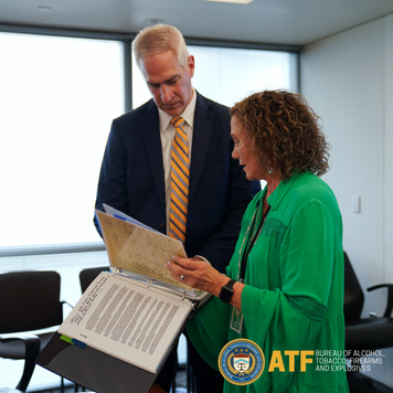 Juanita Green Hollinghead presents historical documents to ATF Assistant Director Brent Beavers